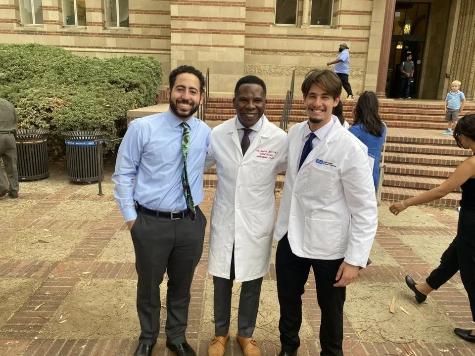 Dr. Ajijola with two lab members.