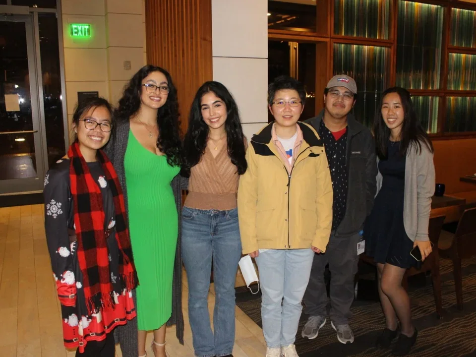Ajijola Lab Members standing indoors and smiling.
