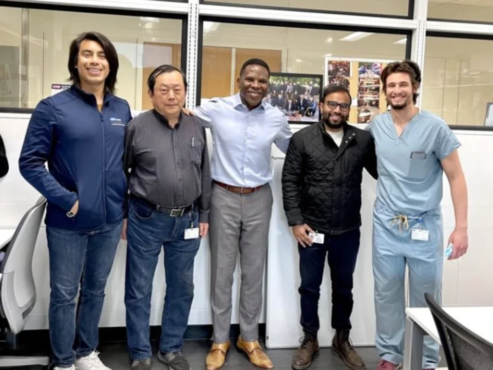 Dr. Ajijola with three other lab members.